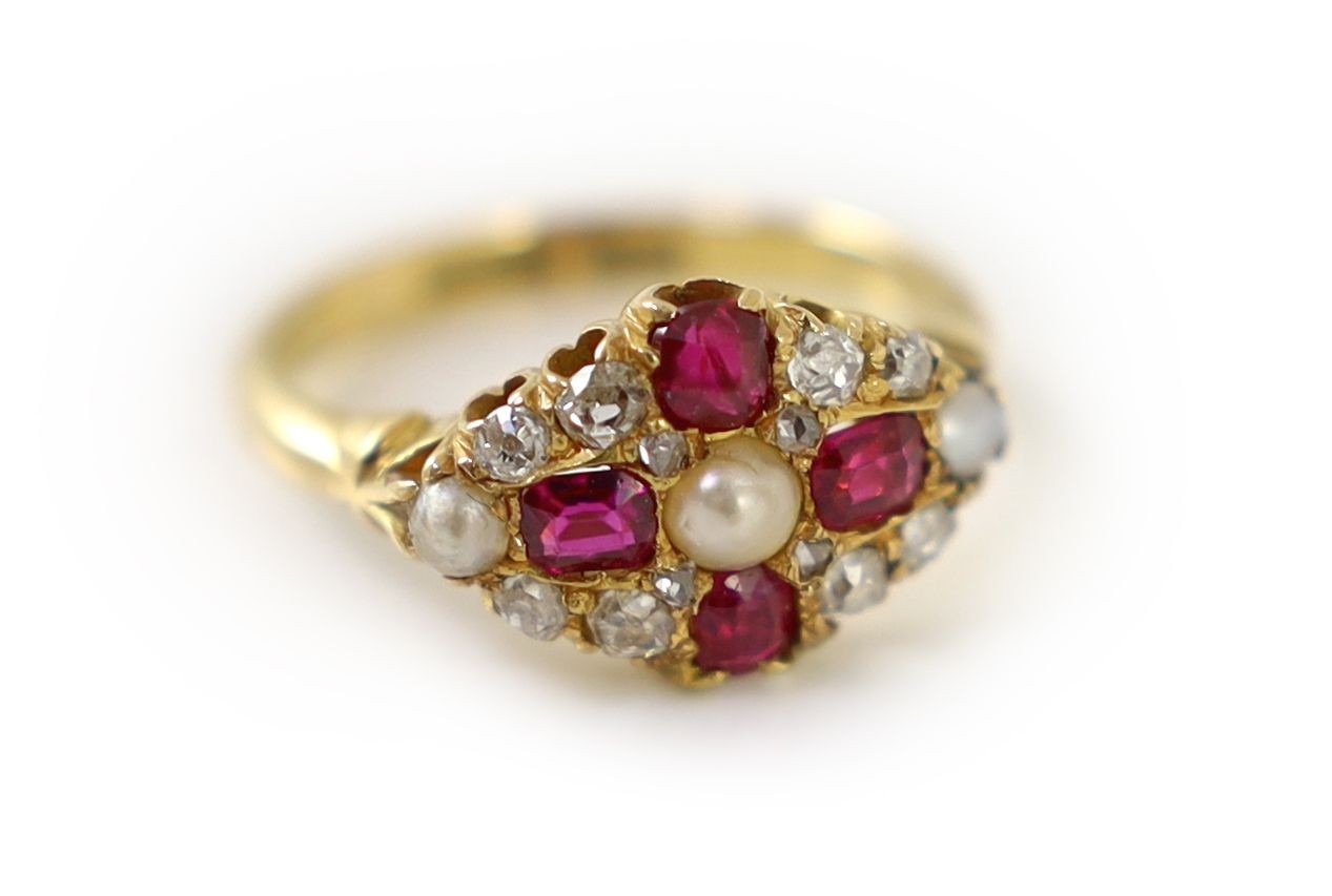 An early 20th century 18ct gold, ruby, diamond and split pearl cluster set dress ring